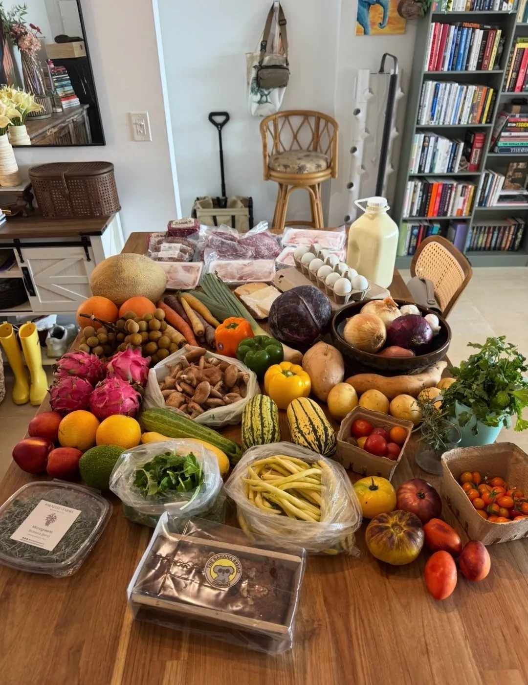 Fresh groceries laid out on a counter: greens, berries, and pantry staples